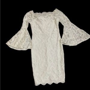 White dress. Knee length. Bell sleeves.